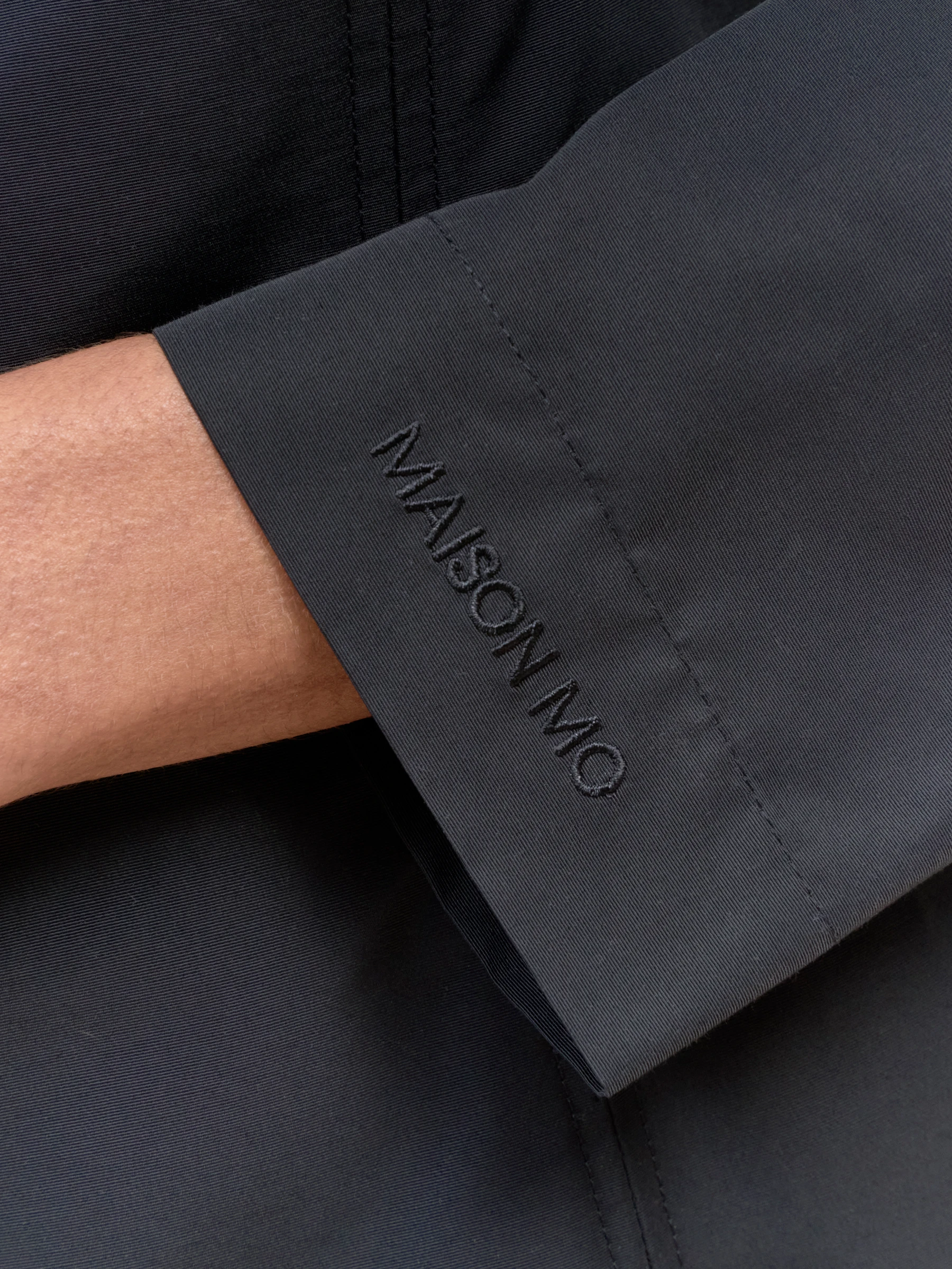 Long sleeve black mini dress in Carbon, detail showing cuff of long sleeve dress