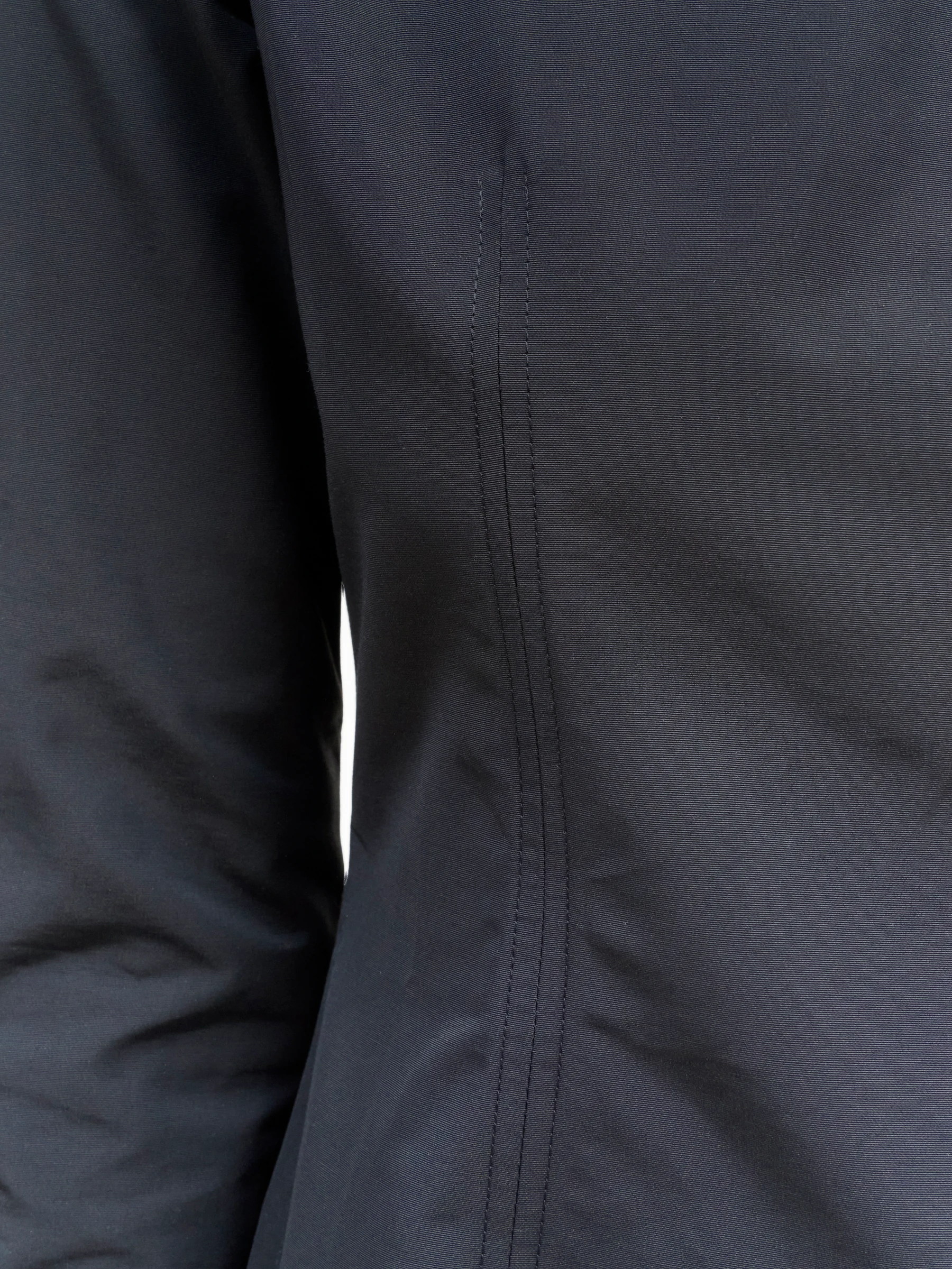 Long sleeve black mini dress in Carbon, detail showing seam of black dress