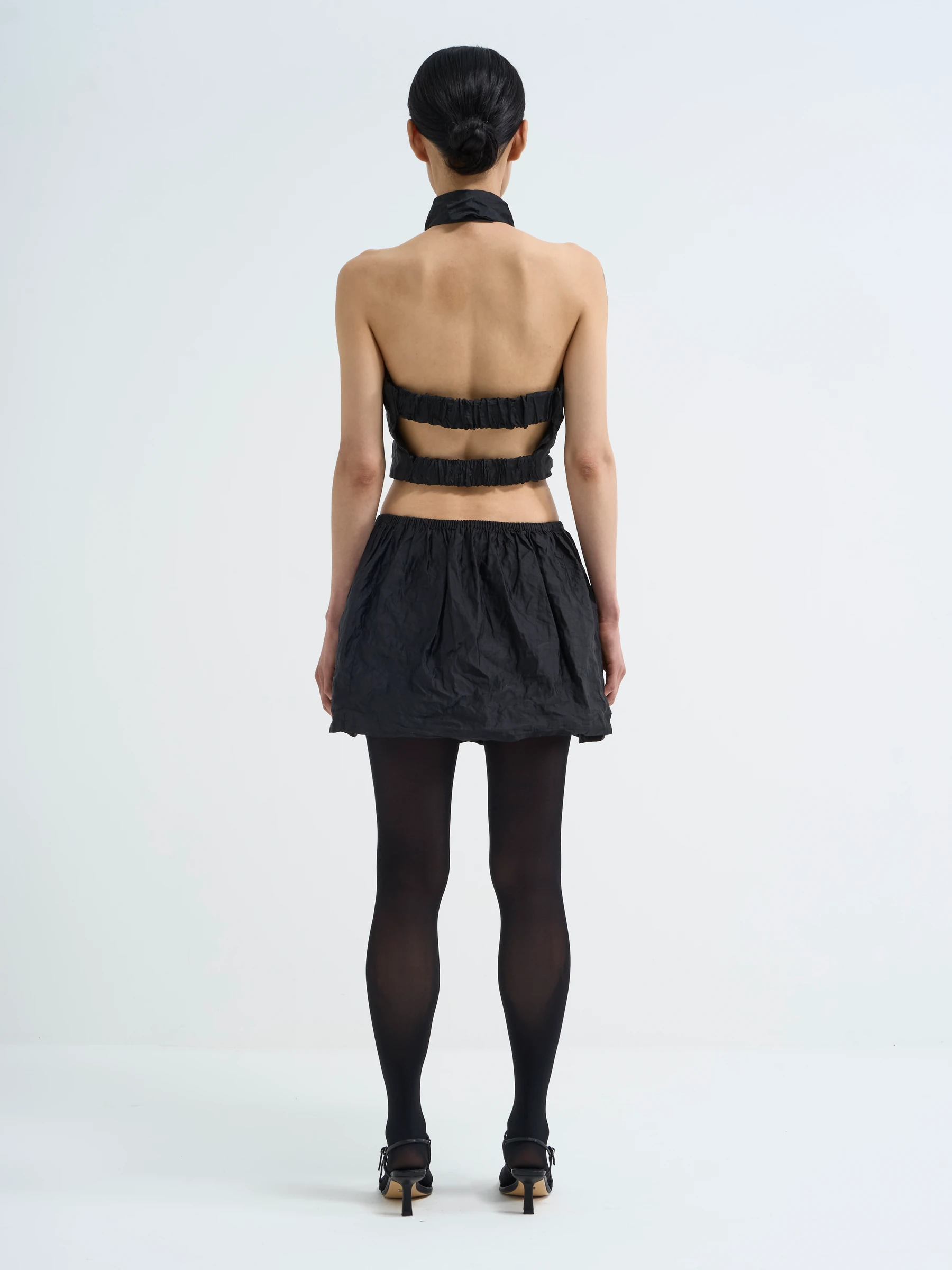 Black bubble skirt in Carbon crease, back view