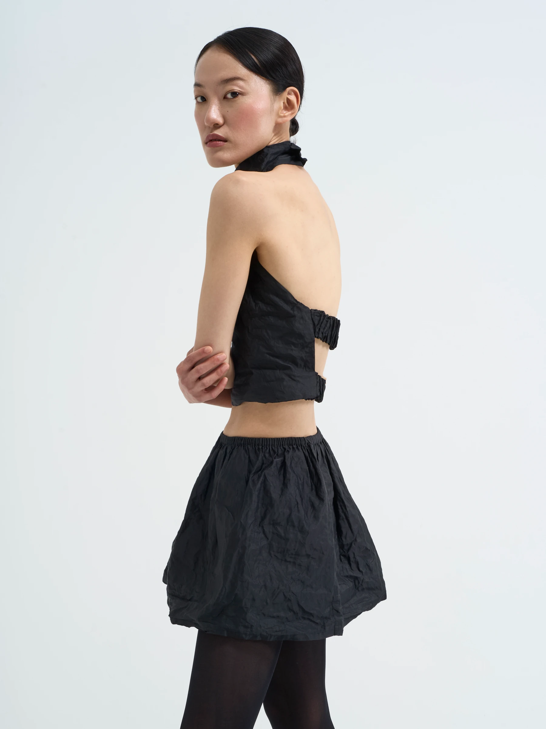 Black bubble skirt in Carbon crease, side view