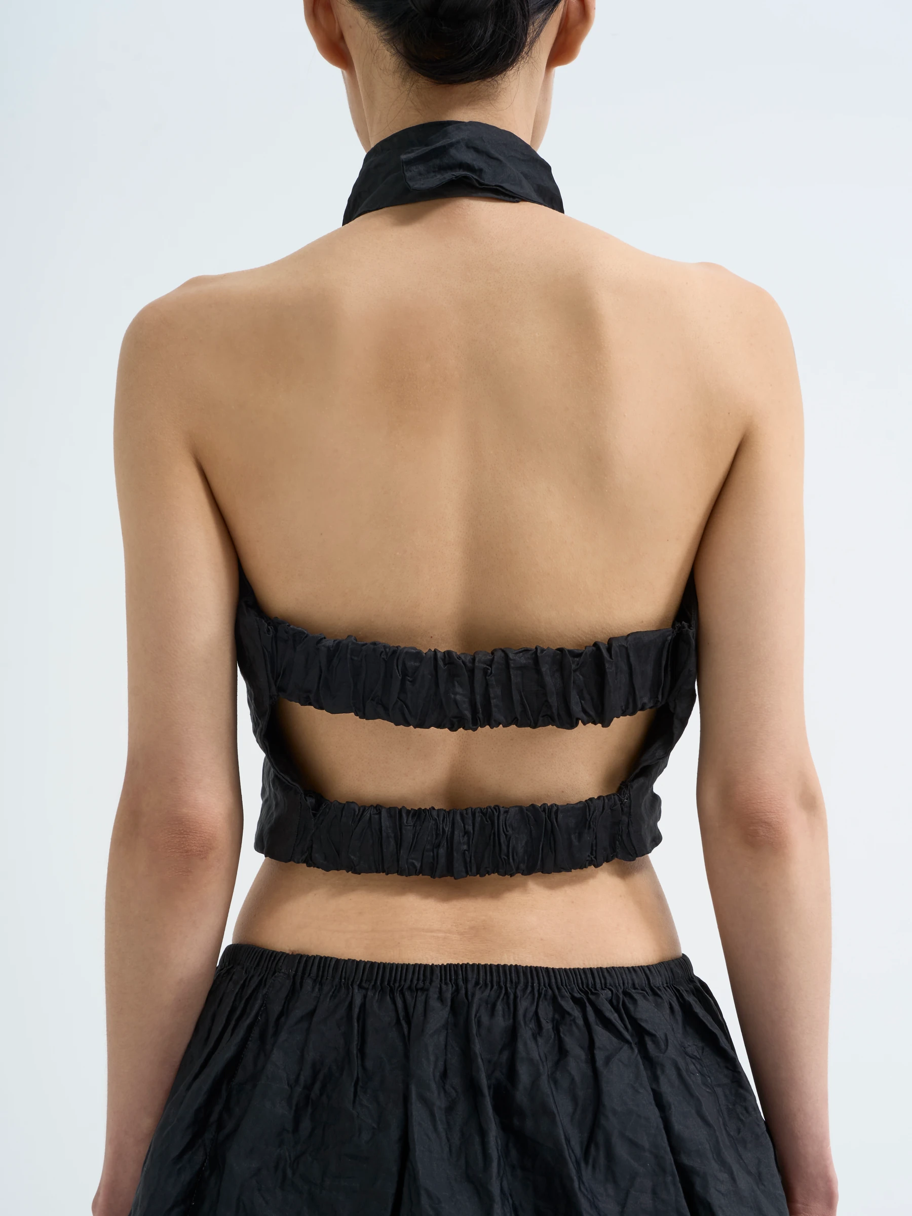 Black halter top in Carbon crease, back view