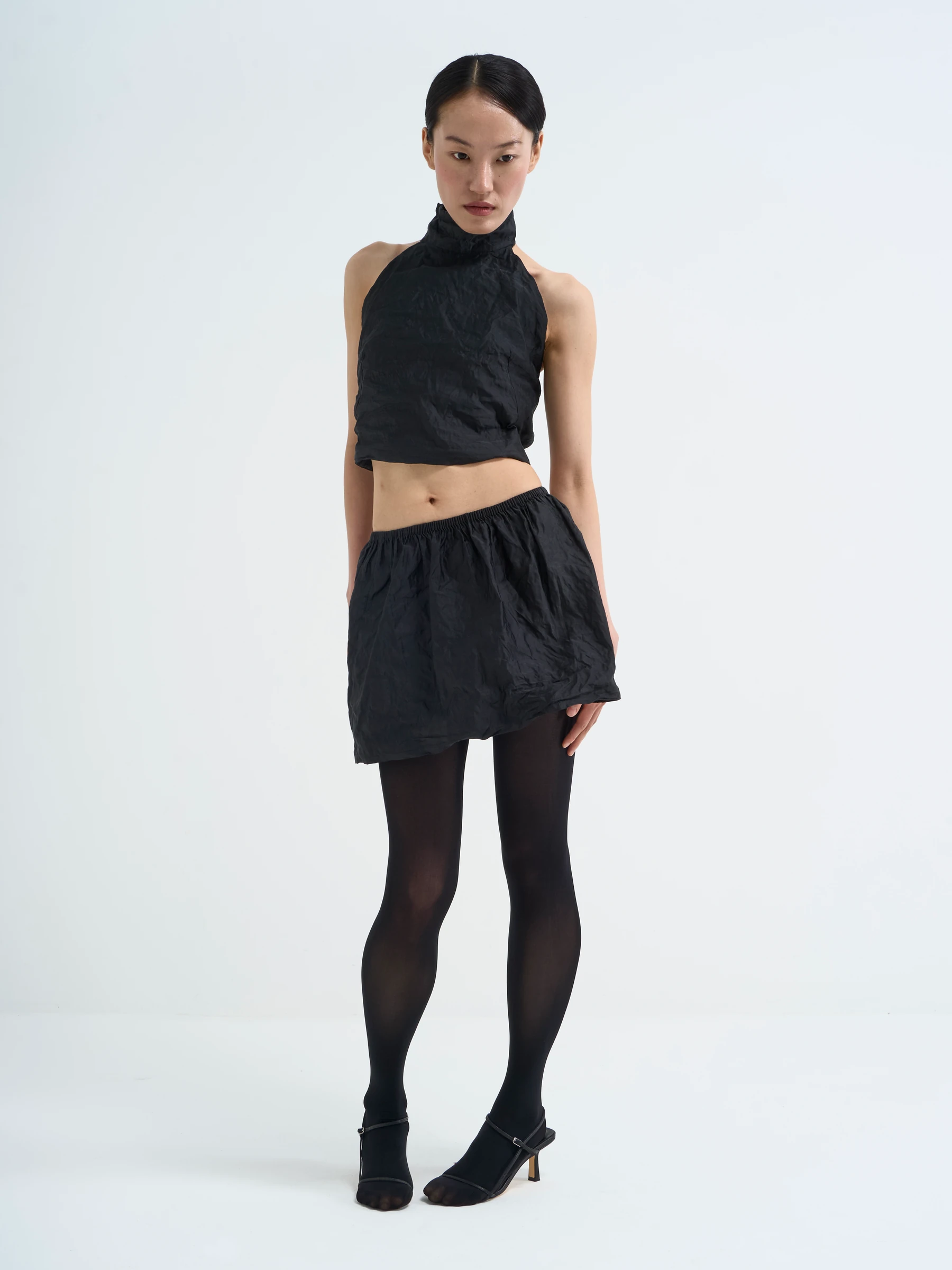 Black halter top in Carbon crease, front view