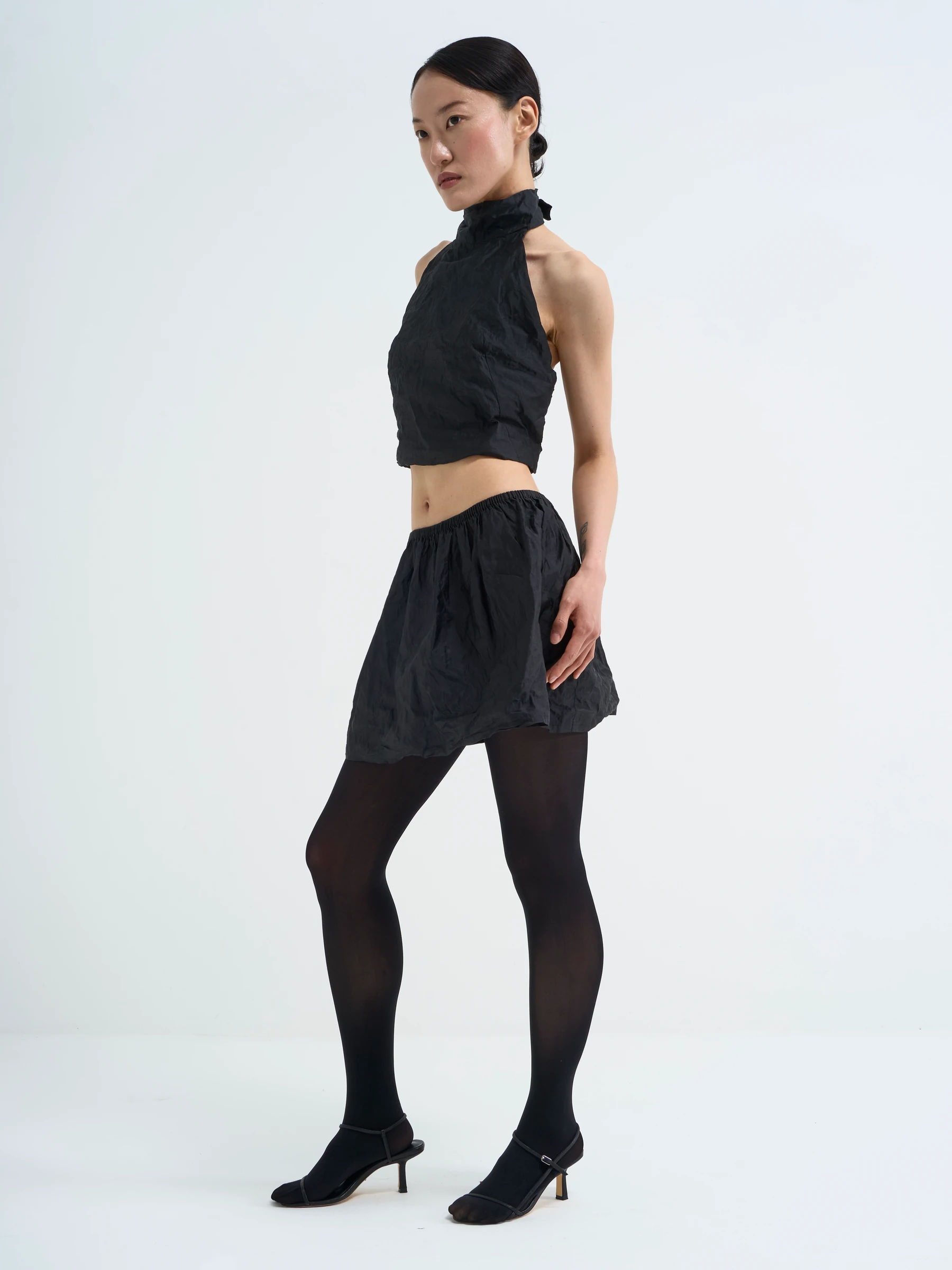 Black halter top in Carbon crease, side view