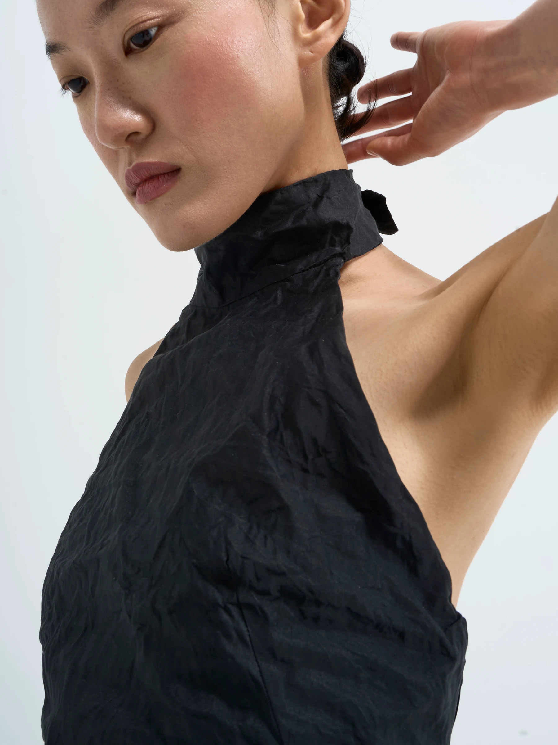 Black halter top in Carbon crease, side view