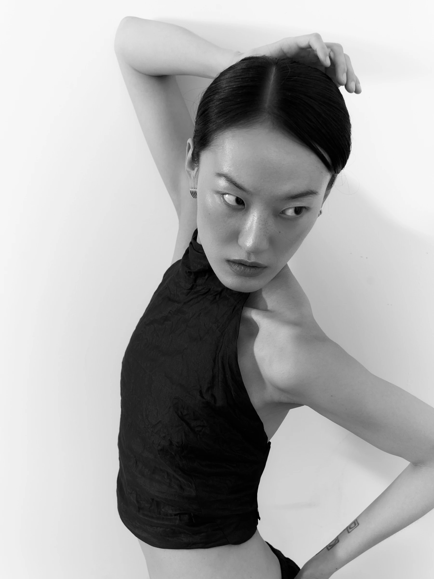 Black halter top in Carbon crease, three-quarter view