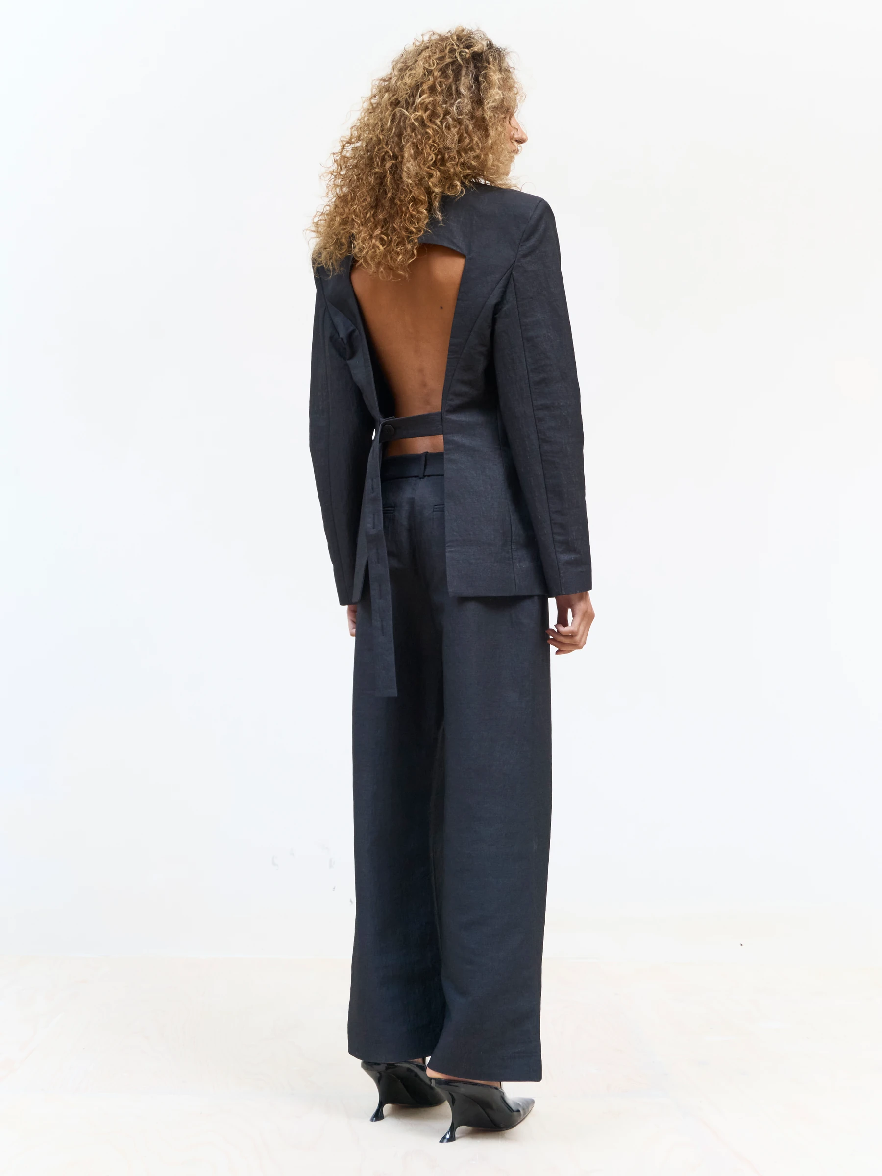 Black backless blazer in 9B, back view