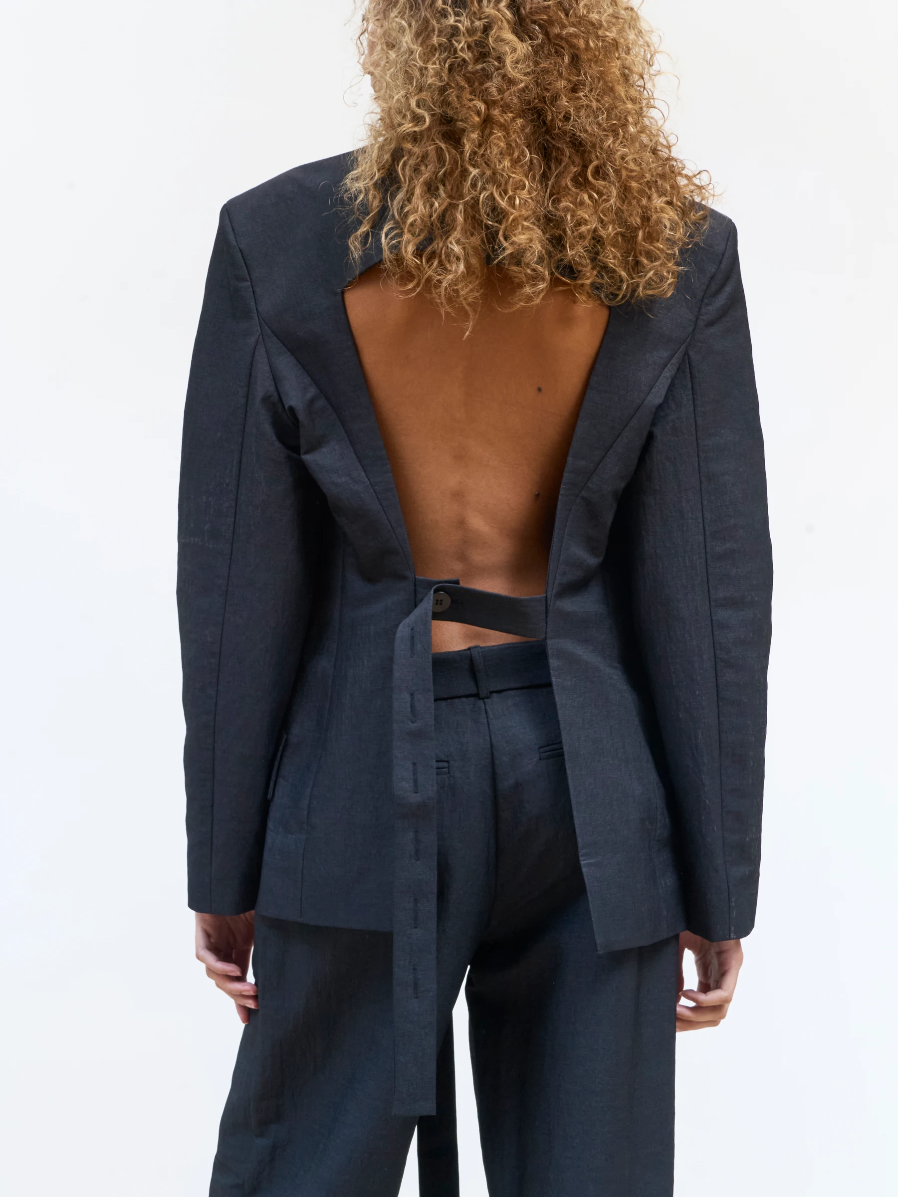 Black backless blazer in 9B, back view