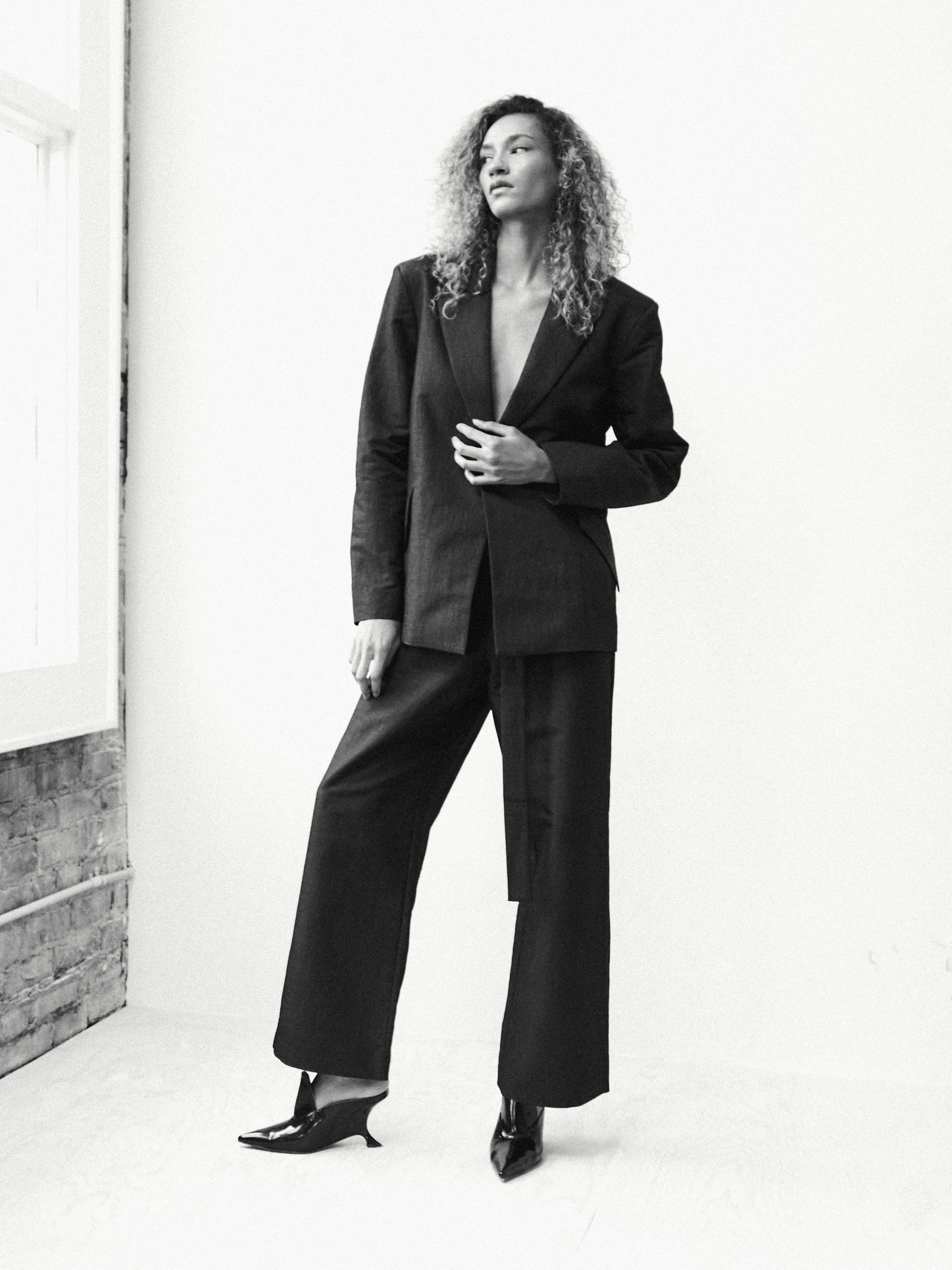 Black backless blazer in 9B, three-quarter view